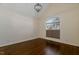 Bright bedroom with a vaulted ceiling, hardwood floors, and a large window at 9413 Lake Villa Way, Raleigh, NC 27614