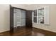 Cozy bedroom with hardwood floors, closet, and bright windows with shutters at 9413 Lake Villa Way, Raleigh, NC 27614
