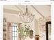 A rustic chandelier hangs above a dining area, with greenery and natural light illuminating the space at 9413 Lake Villa Way, Raleigh, NC 27614