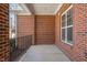 Inviting covered porch showcasing classic brickwork, providing a comfortable outdoor space at 9413 Lake Villa Way, Raleigh, NC 27614