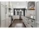 Modern kitchen with stainless steel appliances, granite countertops, dark walls, and custom cabinetry at 9413 Lake Villa Way, Raleigh, NC 27614