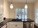 Modern kitchen with stainless appliances, granite countertops, and large windows for natural light at 9413 Lake Villa Way, Raleigh, NC 27614