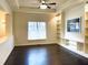 The room features hardwood floors, a large window, built-in shelving, and recessed lighting at 9413 Lake Villa Way, Raleigh, NC 27614
