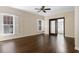 Sun-filled living room boasting hardwood floors and detailed wall trim and large windows at 9413 Lake Villa Way, Raleigh, NC 27614