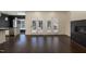 Bright living room features a fireplace, French doors and dark-stained hardwood flooring at 9413 Lake Villa Way, Raleigh, NC 27614
