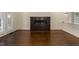 Bright living room features a fireplace, French doors and dark-stained hardwood flooring at 9413 Lake Villa Way, Raleigh, NC 27614