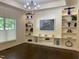 Cozy living room features custom built-ins and a large window with natural light at 9413 Lake Villa Way, Raleigh, NC 27614