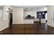 Open-concept living room that flows into kitchen, boasting hardwood floors and plenty of natural light at 9413 Lake Villa Way, Raleigh, NC 27614