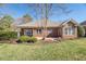 Charming brick home with a well-maintained lawn and patio, perfect for outdoor entertaining and relaxation at 9413 Lake Villa Way, Raleigh, NC 27614