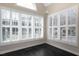 Bright room featuring large windows with white shutters and dark hardwood flooring at 9413 Lake Villa Way, Raleigh, NC 27614