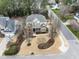 Aerial view of a two-story home featuring well-maintained landscaping and a circular driveway at 100 Tavernelle Pl, Cary, NC 27519