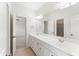 Bright bathroom showcasing a dual sink vanity, tiled floors, and framed mirrors at 100 Tavernelle Pl, Cary, NC 27519