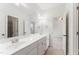 Bright bathroom showcasing a dual sink vanity, tiled floors, and framed mirrors at 100 Tavernelle Pl, Cary, NC 27519