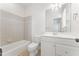 Well-lit bathroom featuring a single sink vanity and a tiled shower-tub combination at 100 Tavernelle Pl, Cary, NC 27519