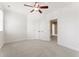 Spacious, bright bedroom with a ceiling fan, plush carpet, and ample closet space at 100 Tavernelle Pl, Cary, NC 27519