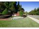 Elegant community entrance featuring brick pillars, manicured landscaping, and a serene setting at 100 Tavernelle Pl, Cary, NC 27519
