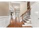 Elegant foyer features hardwood floors, staircase with iron railings and abundant natural light at 100 Tavernelle Pl, Cary, NC 27519