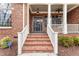 Charming brick home featuring a welcoming front entrance with a well-maintained landscape at 100 Tavernelle Pl, Cary, NC 27519