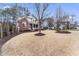 Classic brick home with a manicured lawn, mature trees, and a welcoming front porch at 100 Tavernelle Pl, Cary, NC 27519