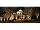 Beautiful brick home illuminated at night, showcasing architectural details and landscaped front yard at 100 Tavernelle Pl, Cary, NC 27519