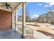 Inviting front porch with brick accents, ceiling fan, and a view of the manicured lawn at 100 Tavernelle Pl, Cary, NC 27519