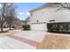 Attached garage showcasing ample parking space and an exterior side view of the home at 100 Tavernelle Pl, Cary, NC 27519