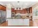 Gourmet kitchen featuring a large island, stainless steel appliances, and beautiful cabinetry at 100 Tavernelle Pl, Cary, NC 27519