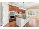 Open kitchen with stainless steel appliances, granite countertops, and a view to the eat in breakfast room at 100 Tavernelle Pl, Cary, NC 27519
