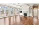 Elegant living room with a fireplace, built-in shelves, detailed trim and french doors to outdoor patio at 100 Tavernelle Pl, Cary, NC 27519