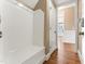 Mudroom area with built-in bench and storage, coat hooks, and hardwood floors at 100 Tavernelle Pl, Cary, NC 27519