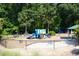 Fenced community playground with colorful equipment, providing a safe and fun environment for children to play and explore at 100 Tavernelle Pl, Cary, NC 27519