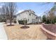 Rear exterior of the home displaying the well-manicured backyard and patio area at 100 Tavernelle Pl, Cary, NC 27519