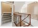 Elegant staircase featuring wood railings, iron spindles, and carpeted steps at 100 Tavernelle Pl, Cary, NC 27519