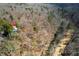 Aerial view showing the house nestled in a wooded setting at 1004 Kings Mill Rd, Chapel Hill, NC 27517