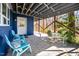 Covered back porch with a seating area, table, and wooded views at 1004 Kings Mill Rd, Chapel Hill, NC 27517
