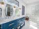 Elegant bathroom featuring dual sinks, custom blue cabinetry and a glass block shower at 1004 Kings Mill Rd, Chapel Hill, NC 27517