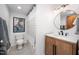 Contemporary bathroom with hexagonal tile flooring, modern vanity and decorative mirror at 1004 Kings Mill Rd, Chapel Hill, NC 27517