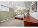 A basement bedroom featuring carpet, natural light, and track lighting at 1004 Kings Mill Rd, Chapel Hill, NC 27517