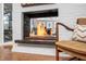 Modern fireplace with a white brick surround and glass stones, creating a cozy focal point in the room at 1004 Kings Mill Rd, Chapel Hill, NC 27517