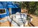 Exterior of the house with a hot tub and stone patio in a wooded area at 1004 Kings Mill Rd, Chapel Hill, NC 27517