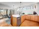 Modern kitchen with stainless steel appliances, wooden cabinets, white countertops, and unique lighting fixtures at 1004 Kings Mill Rd, Chapel Hill, NC 27517