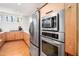 Spacious kitchen features stainless steel appliances, bright lighting, wooden cabinets, and white countertops at 1004 Kings Mill Rd, Chapel Hill, NC 27517