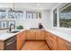 Modern kitchen with stainless steel appliances, ample counter space, and a sink with views of the outdoors at 1004 Kings Mill Rd, Chapel Hill, NC 27517