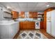 A basement kitchen with wooden cabinetry, tile backsplash, and a washer and dryer at 1004 Kings Mill Rd, Chapel Hill, NC 27517