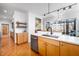 Bright kitchen with stainless steel appliances and a kitchen island for a functional and stylish cooking space at 1004 Kings Mill Rd, Chapel Hill, NC 27517