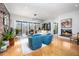 Spacious living room featuring a modern fireplace, sleek lighting, and large windows offering abundant natural light at 1004 Kings Mill Rd, Chapel Hill, NC 27517