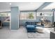 Comfortable living area showcasing a plush blue sofa and natural light at 1004 Kings Mill Rd, Chapel Hill, NC 27517