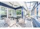 Beautiful sunroom with a ceiling fan, comfortable seating, dining table, and a view of the outdoors at 1004 Kings Mill Rd, Chapel Hill, NC 27517
