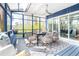 Relaxing sunroom featuring comfortable seating and scenic views, perfect for enjoying the outdoors year-round at 1004 Kings Mill Rd, Chapel Hill, NC 27517