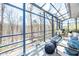 Sunroom with comfortable seating and glass windows providing plenty of natural light and views of the outdoors at 1004 Kings Mill Rd, Chapel Hill, NC 27517